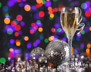 Champagne glass and disco balls on colorful background